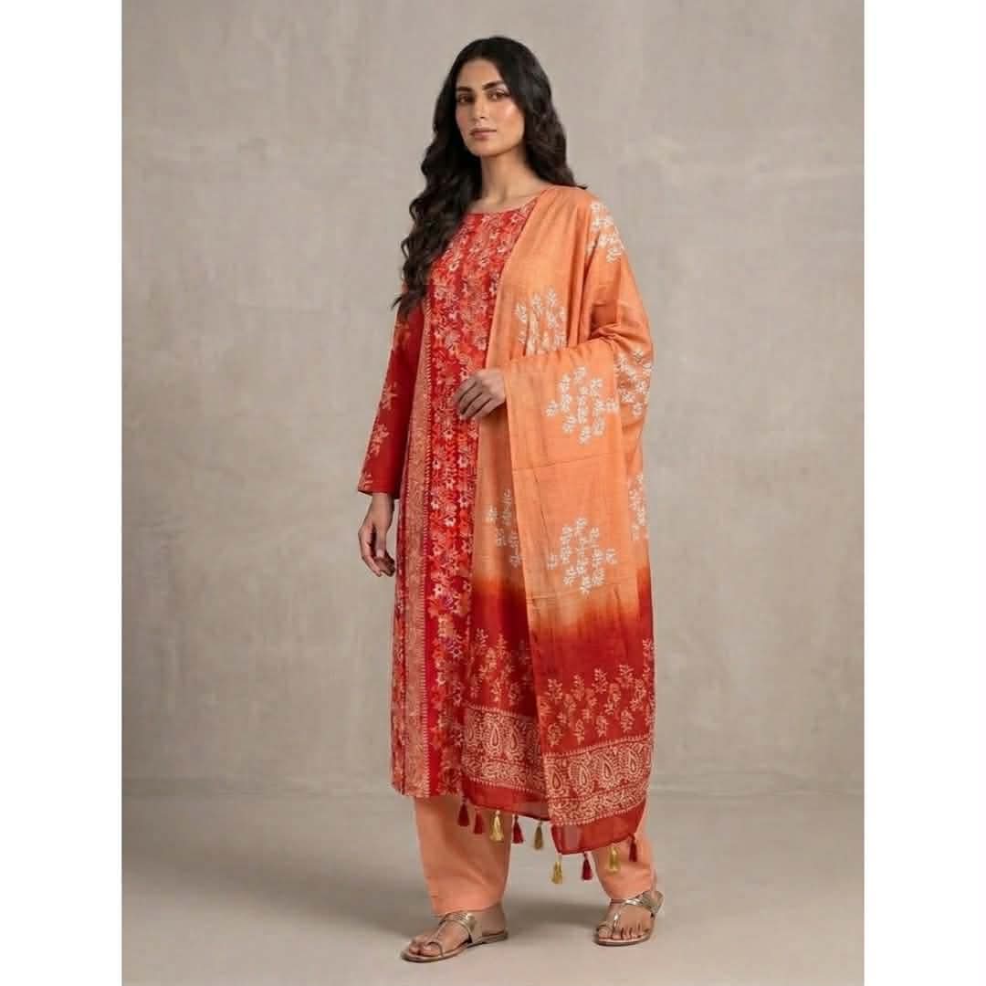Woman wearing elegant orange and red batik printed cotton three piece dress with printed dupatta