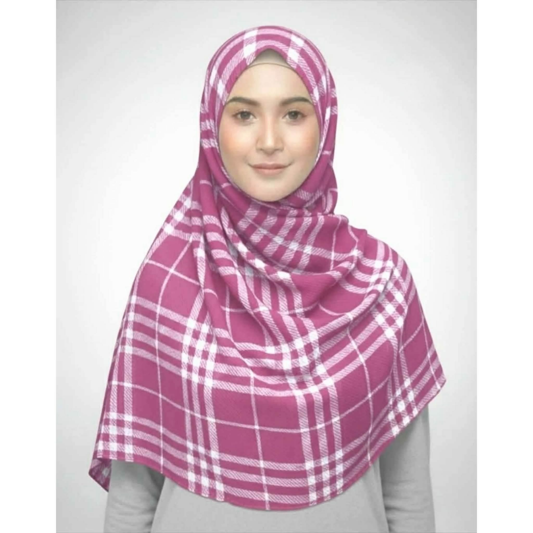 A woman wearing a magenta pink and white plaid crepe print hijab scarf, size 80x33 inches.