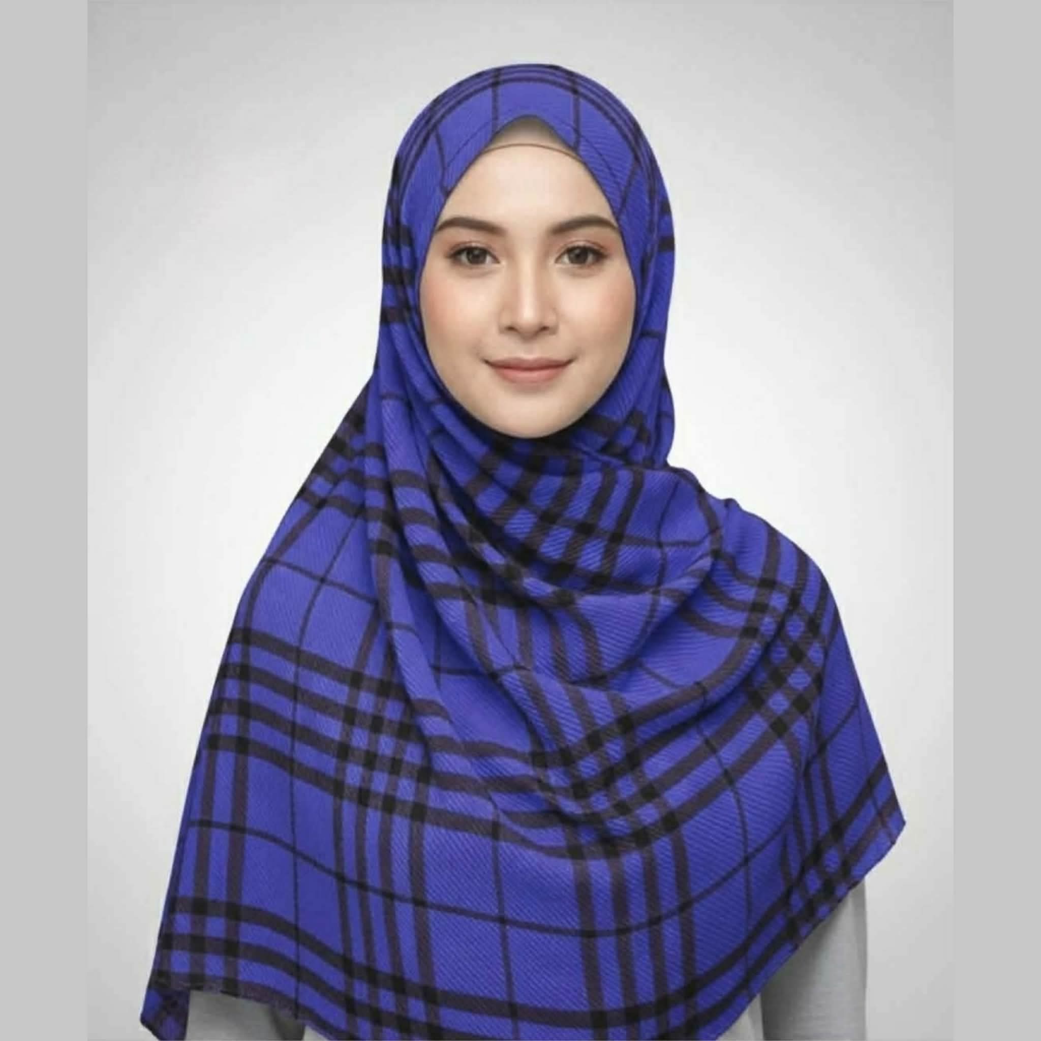 Woman wearing a royal blue checkered crepe printed hijab with black grid lines